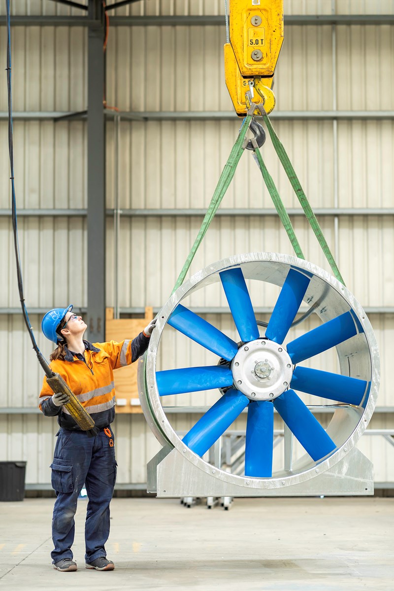 Woman handling a machine by crane